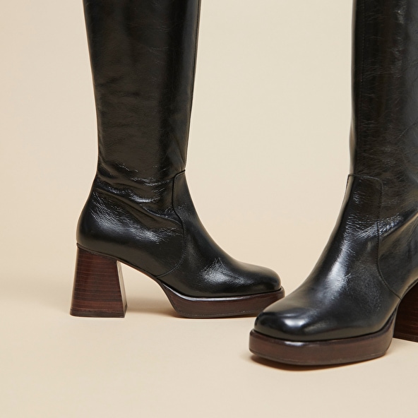 Platform boots in aged black leather