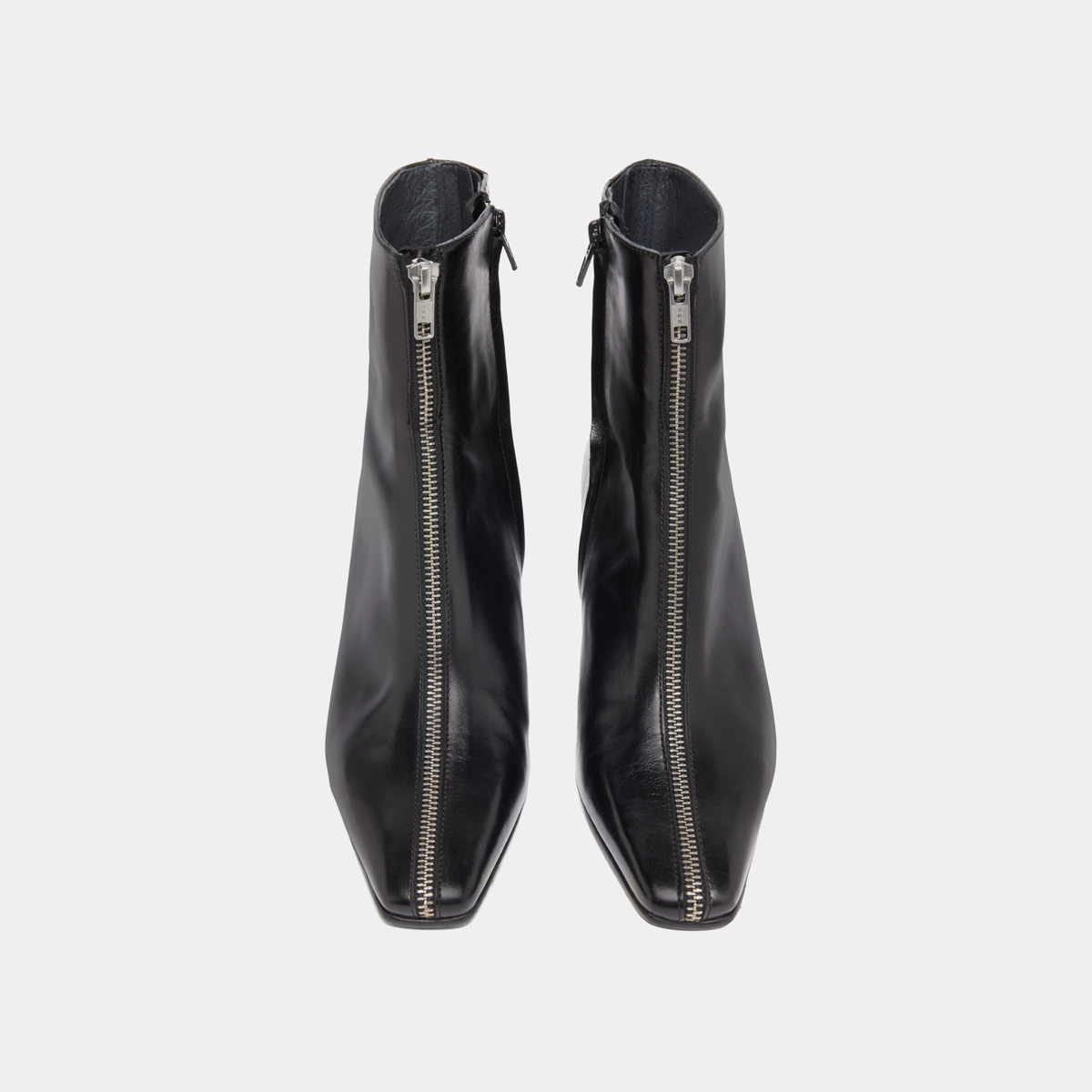 Heeled ankle boots with front zippers in black leather | DANZA