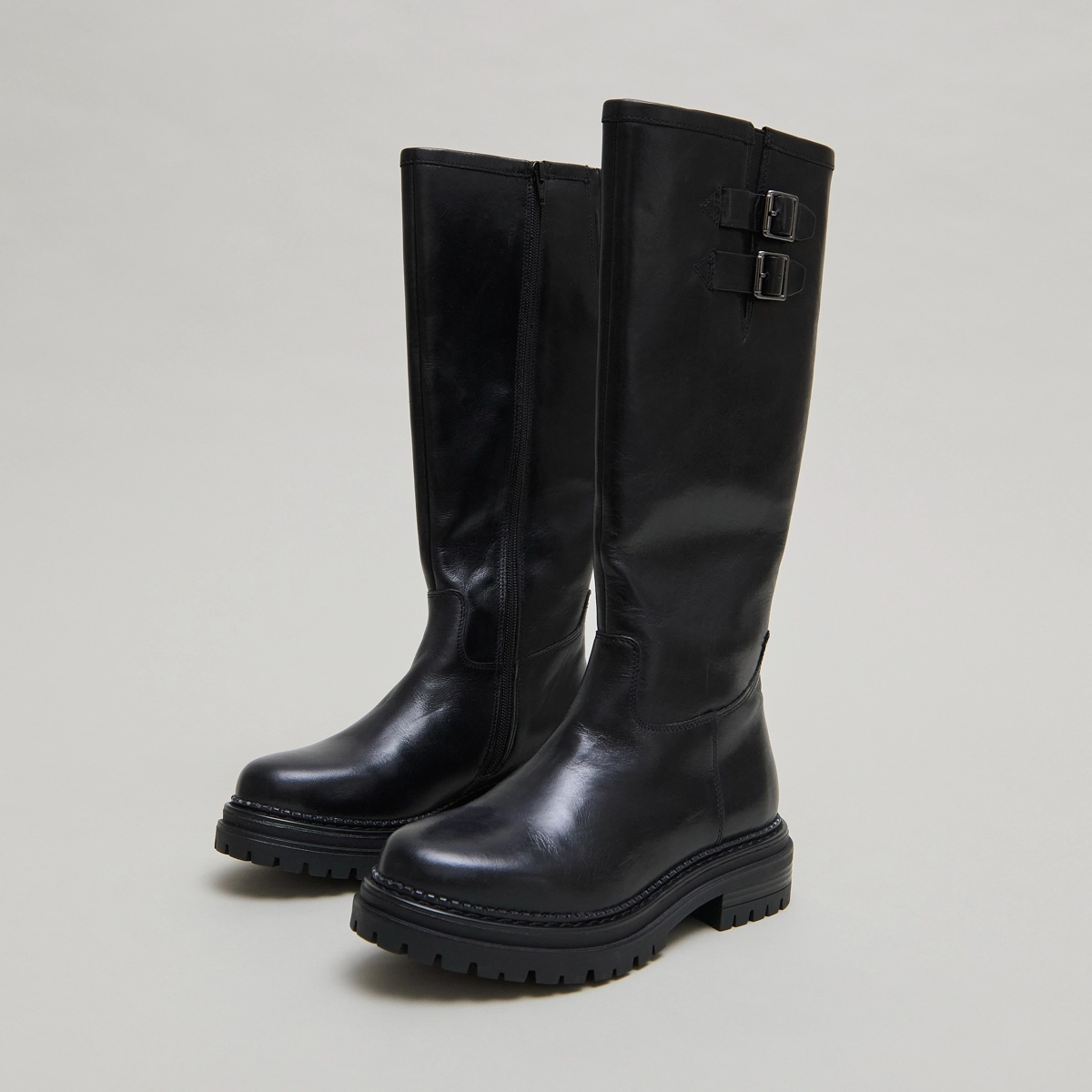 High boots with notched soles and buckles in black leather | ADALIA