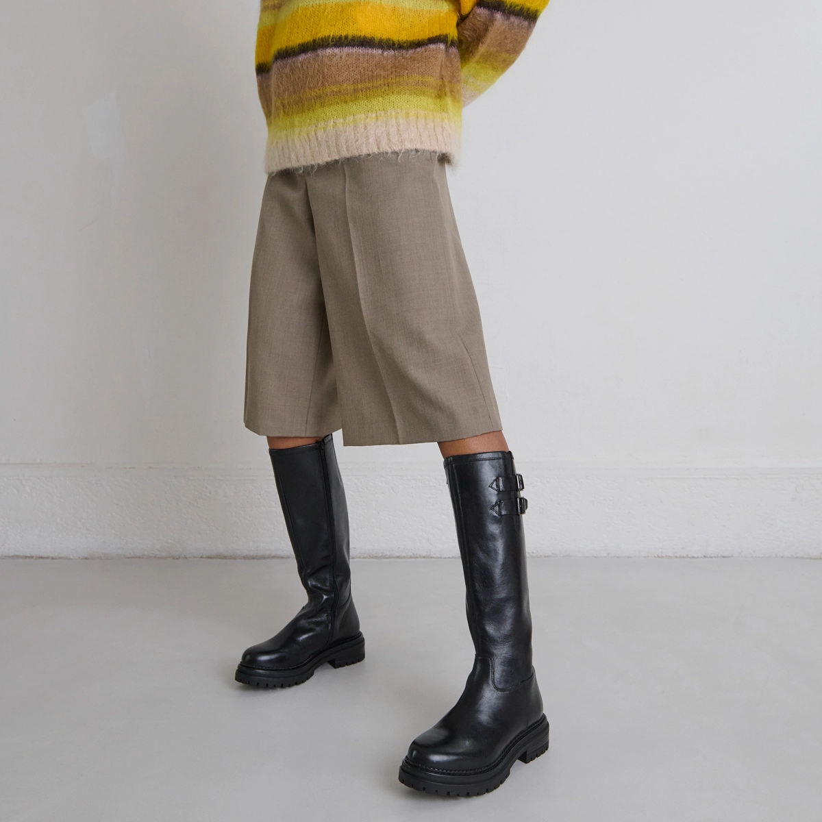 High boots with notched soles and buckles in black leather | ADALIA