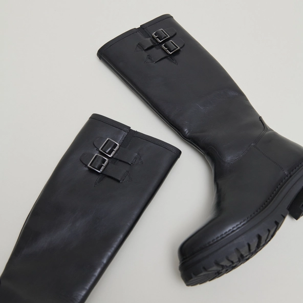 High boots with notched soles and buckles in black leather | ADALIA