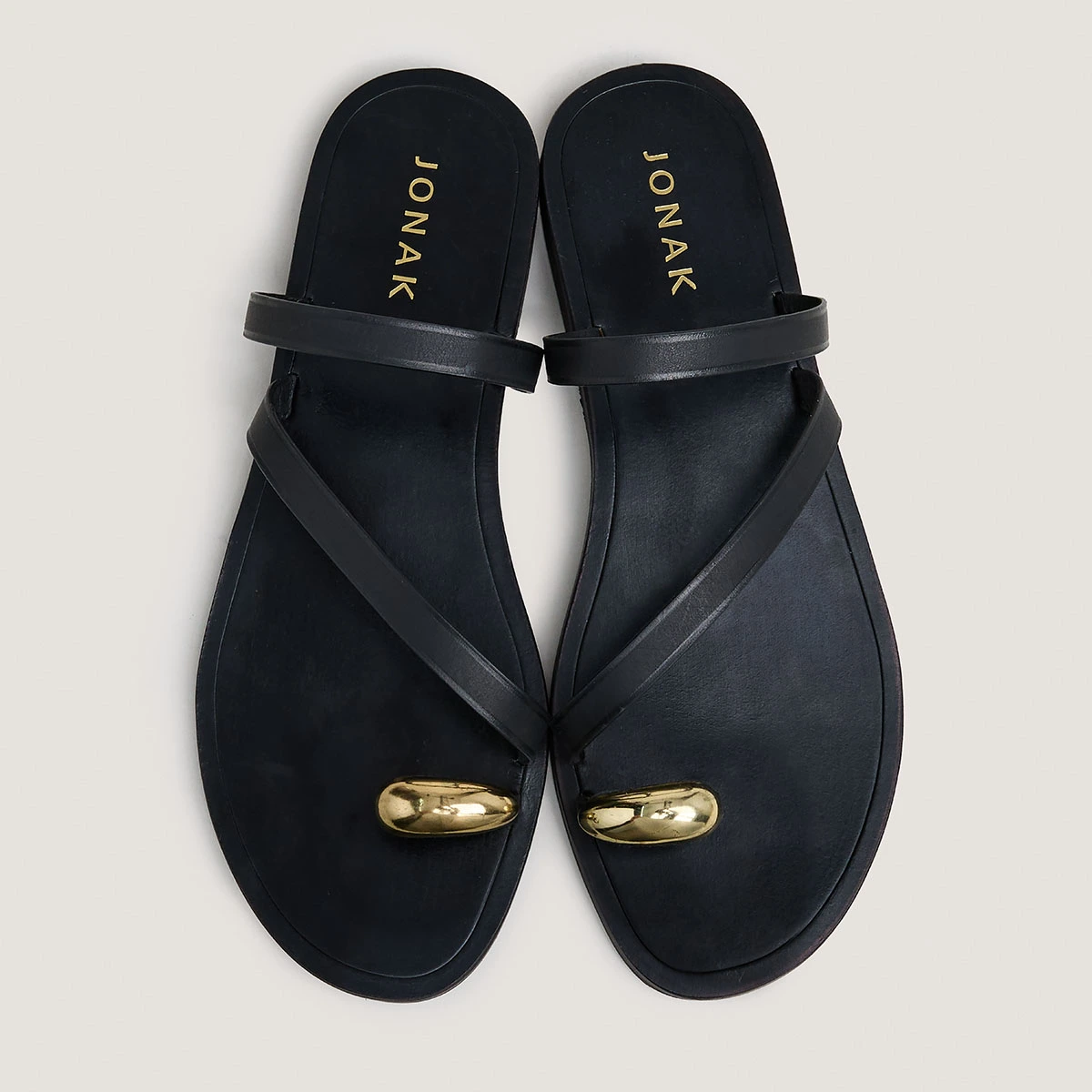 Sandals with slender straps and gold details in black leather | WIFE