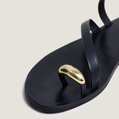 Sandals with slender straps and gold details in black leather | wife