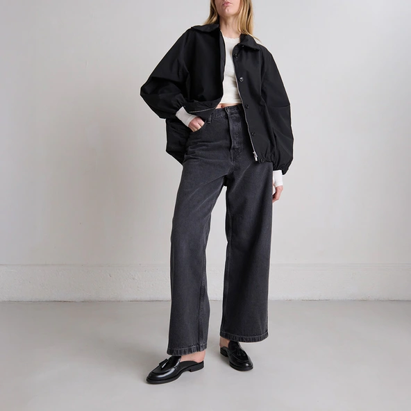 Loafers with tassels and open backs in black glazed leather | NATALY
