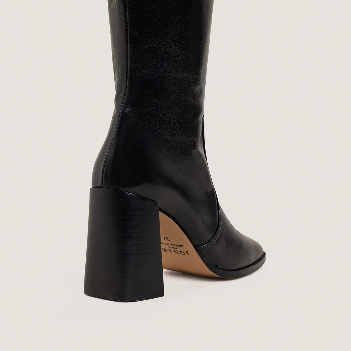 High-heeled boots in aged black leather | VAUBY