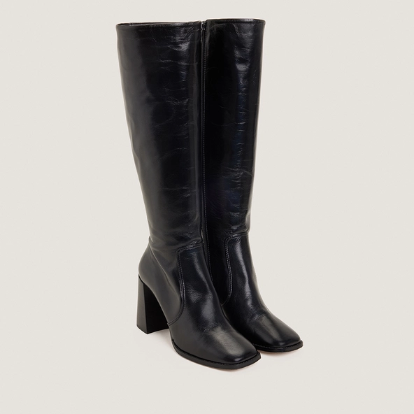 High-heeled boots in aged black leather | VAUBY