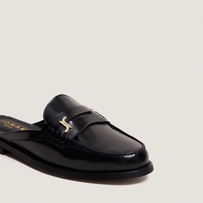 Backless loafers with monogram detailing in black patent leather | amaury