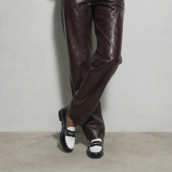 Penny loafers with a pinched platform in black and white patent leather | AUDELYA