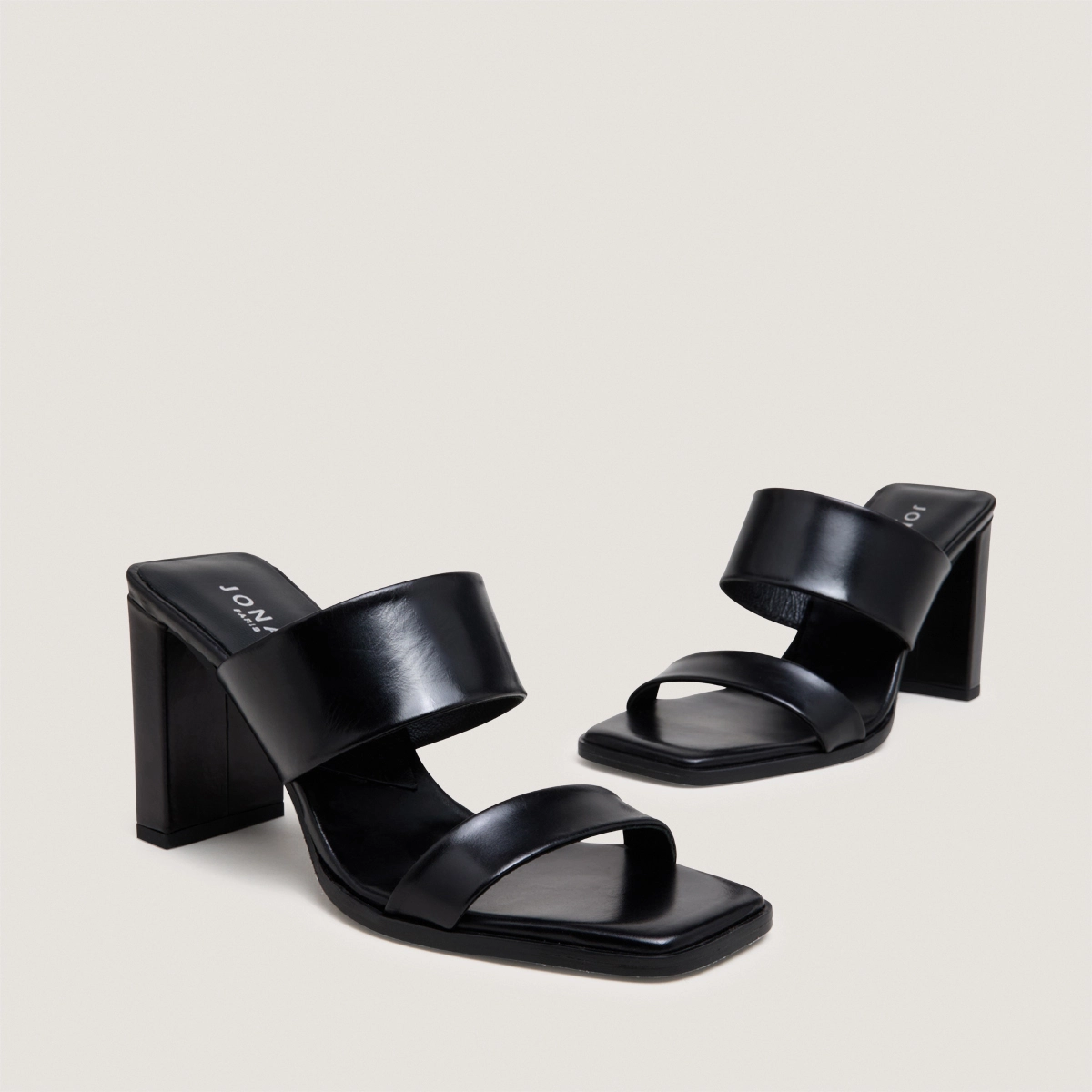 Heeled mules with double straps in black leather | BRITNEY