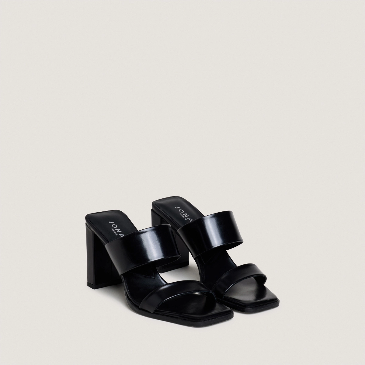 Heeled mules with double straps in black leather | BRITNEY