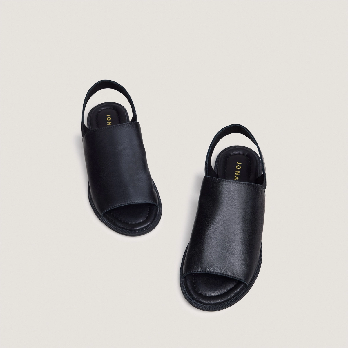 Elastic-strap sandals in black leather | JESS