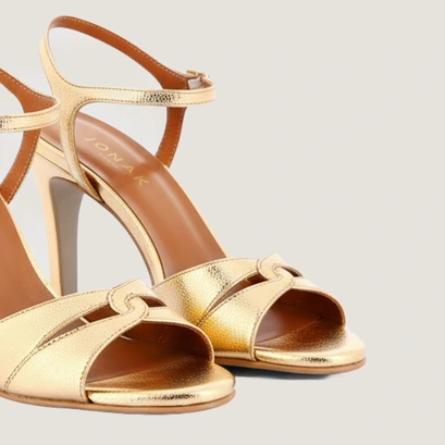 Heeled sandals with intertwined straps in gold crackled leather | diwi