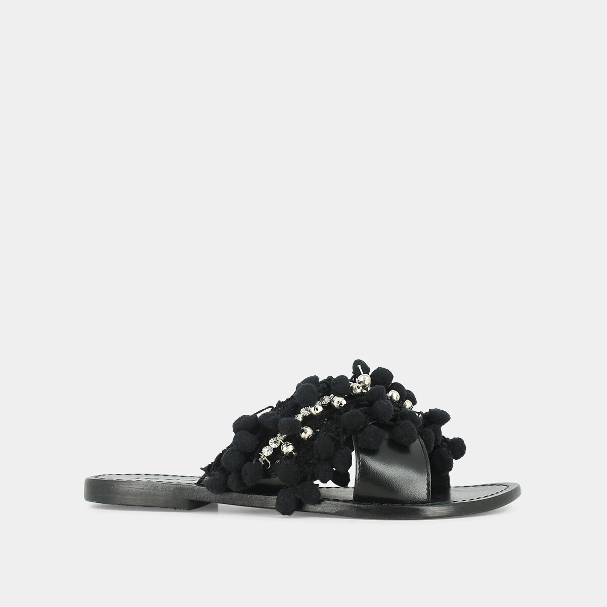 Mules in black leather and textile with pompoms and beads | JACK