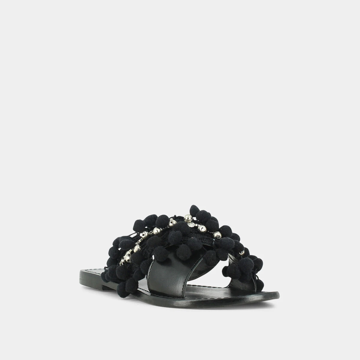 Mules in black leather and textile with pompoms and beads | JACK