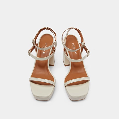 Strap and platform sandals in unbleached distressed leather