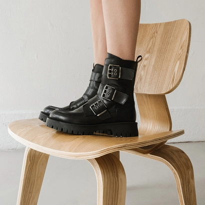 Boots with notched soles and straps in black leather | runner