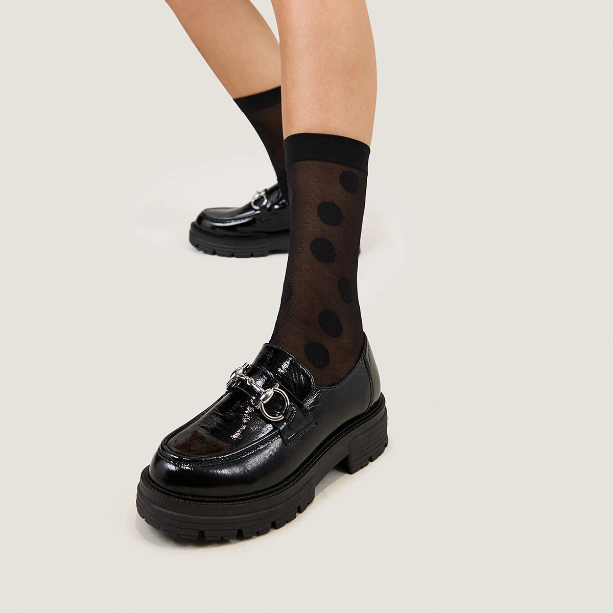 Moccasins with bits and notched soles in black pleated patent | ANTON