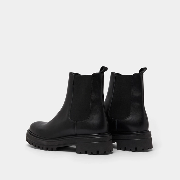 Boots with notched and elastic soles in black leather | AMANDINE
