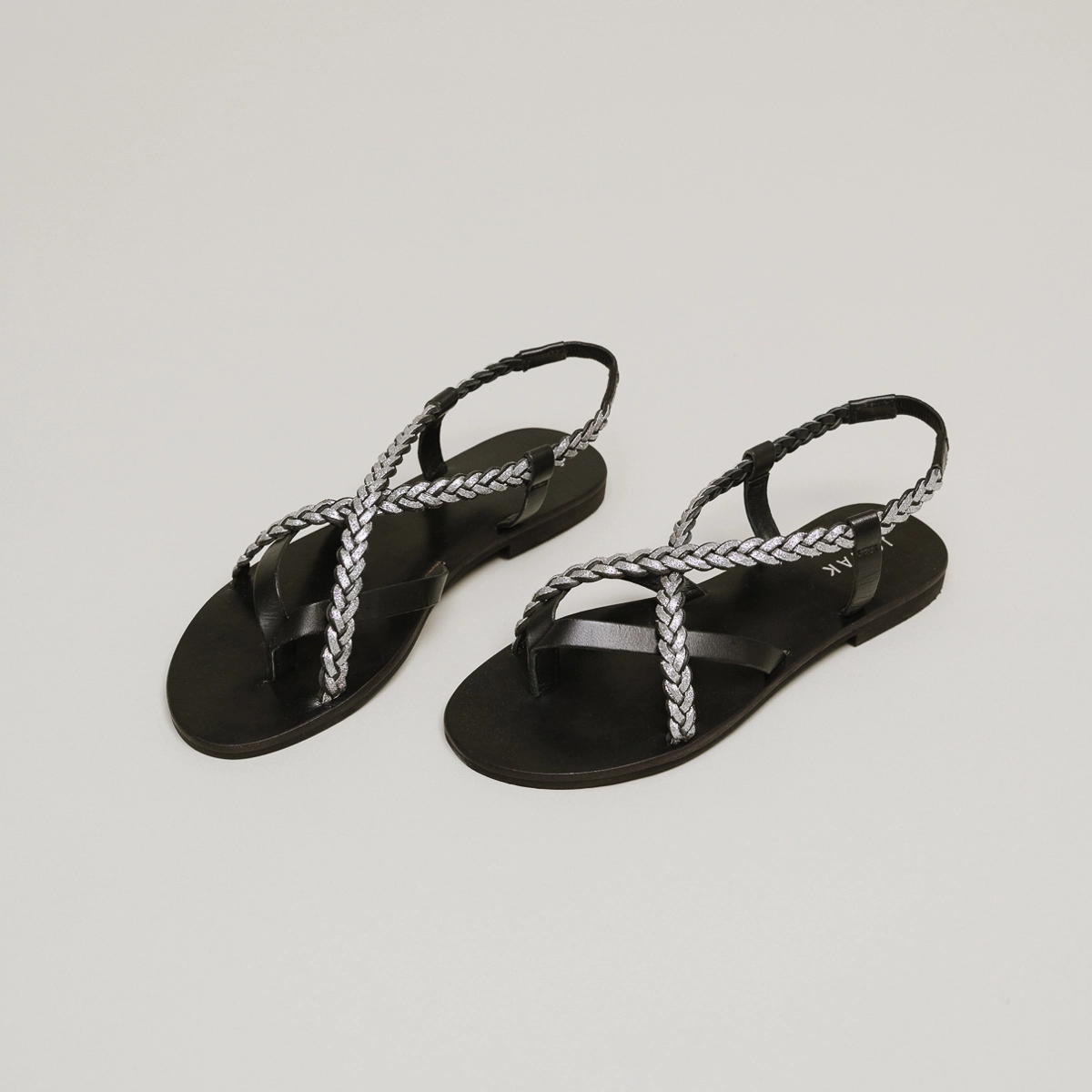Sandals with braided straps in black and silver leather | WARREN