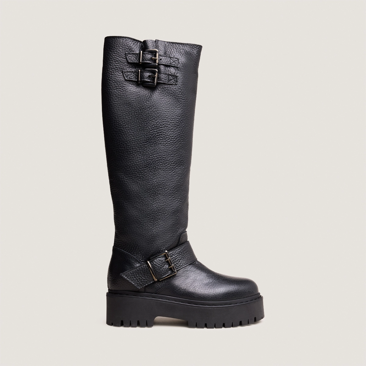 Boots with straps and notched soles in black grained leather | REINE
