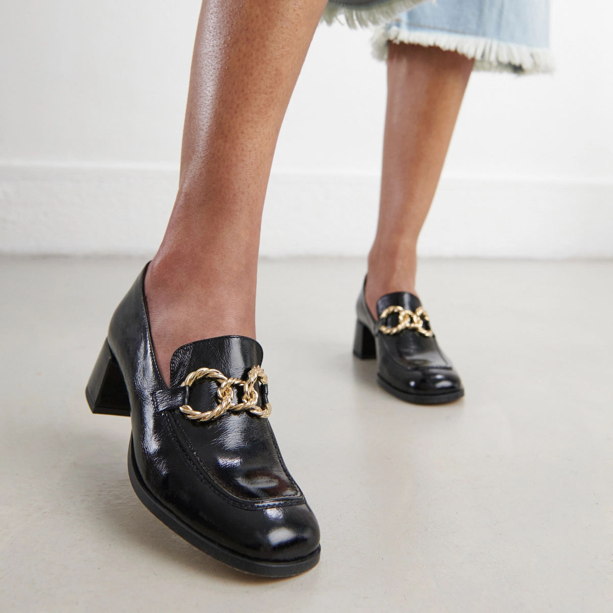 Round-toed loafers with gold buckles in black glazed leather | VINCENNES