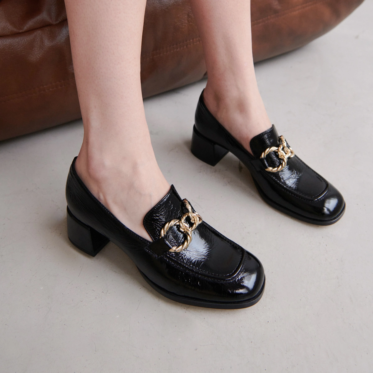 Round-toed loafers with gold buckles in black glazed leather | VINCENNES
