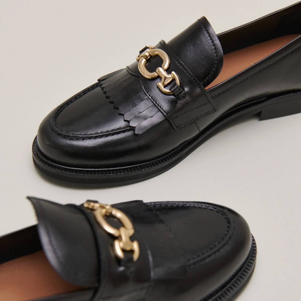 Loafers with gold buckles in black leather | DELPHES