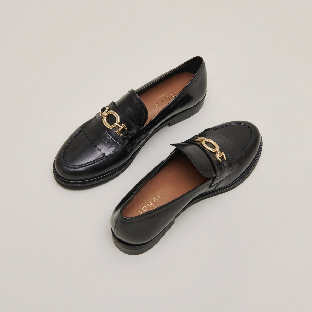 Loafers with gold buckles in black leather | DELPHES