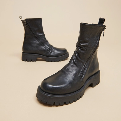 Boots with zips and notched soles in black aged leather | ROLIN