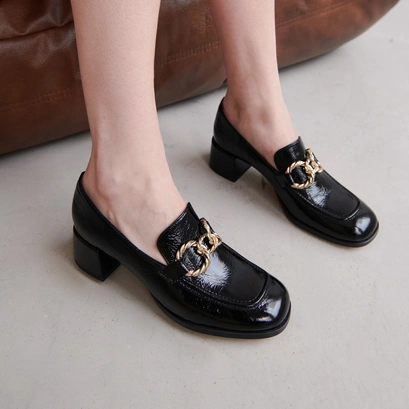 Round-toed loafers with gold buckles in black glazed leather | vincennes