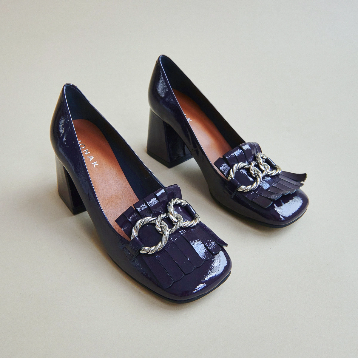 Heeled loafers with silver buckles in purple pleated patent | DOMITILLE