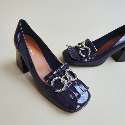 Heeled loafers with silver buckles in purple pleated patent | domitille