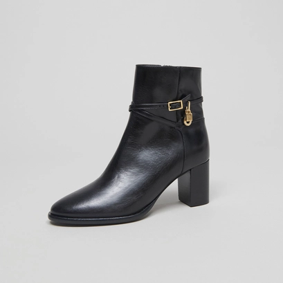 Ankle boots with high heels and gold charms in black leather | drame