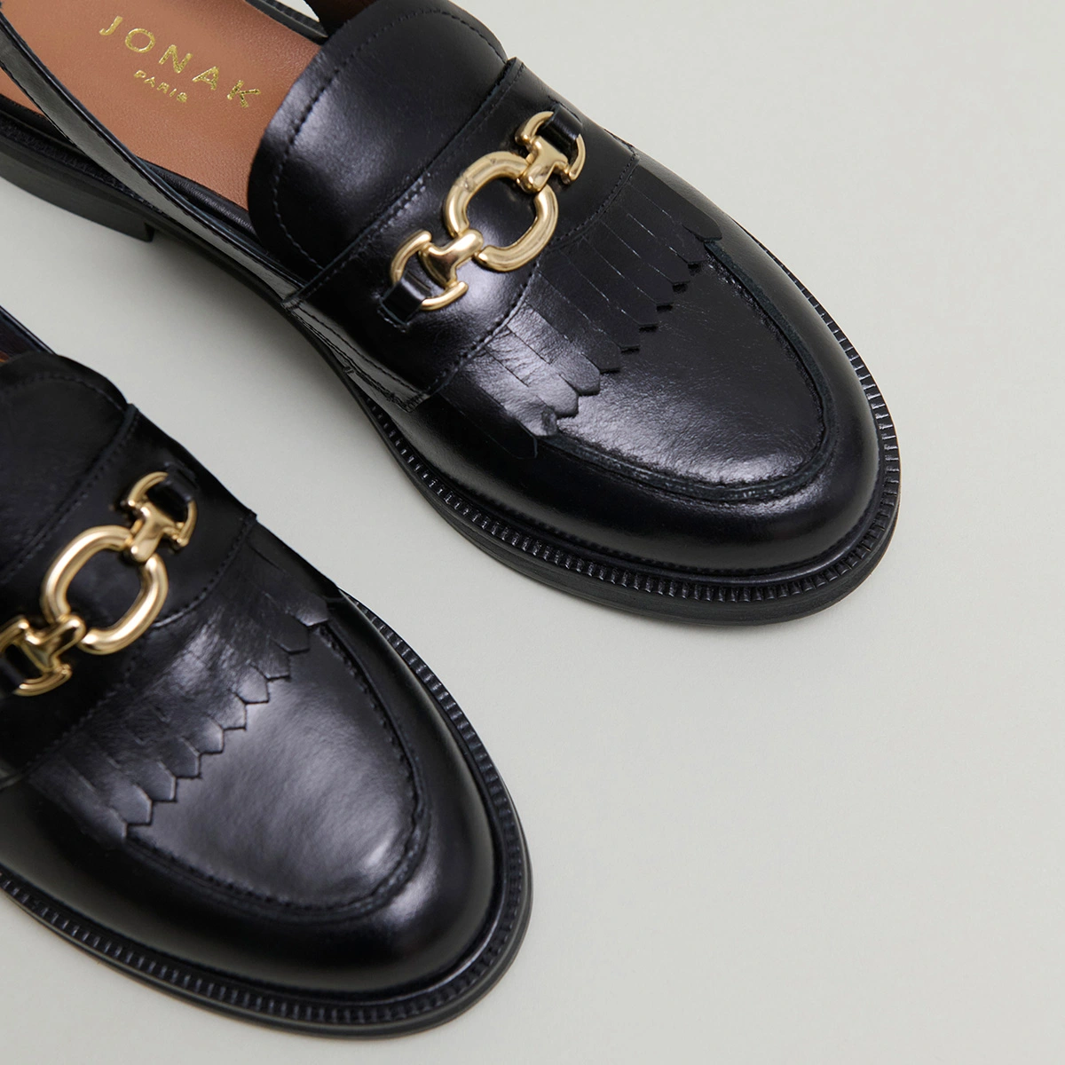 Loafers with open backs in black leather | DELPHY
