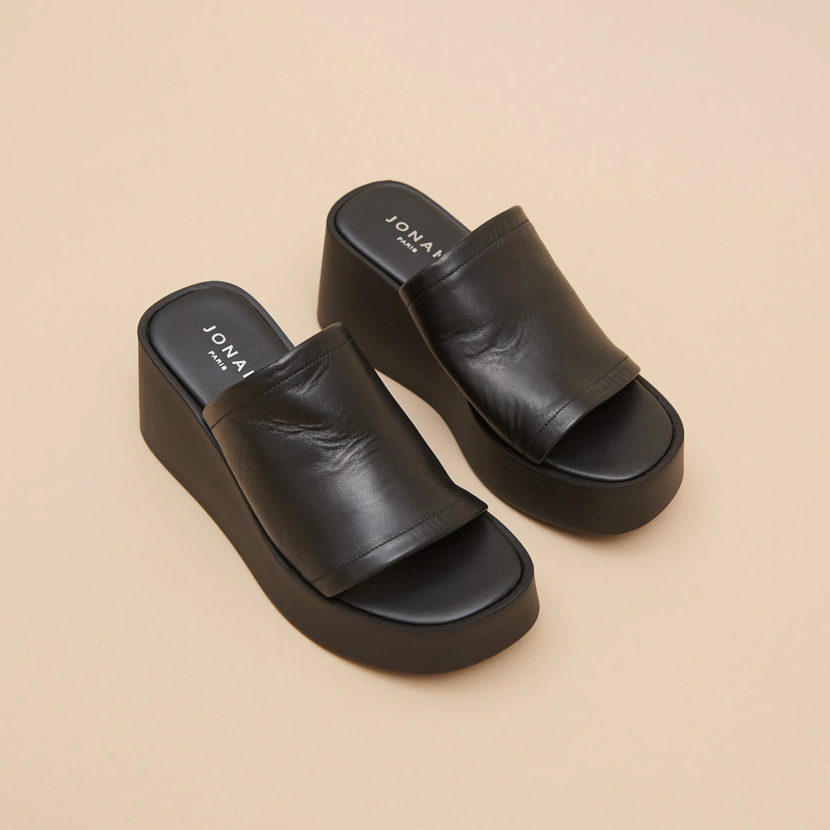 Wedge mules in black leather | EUGENE