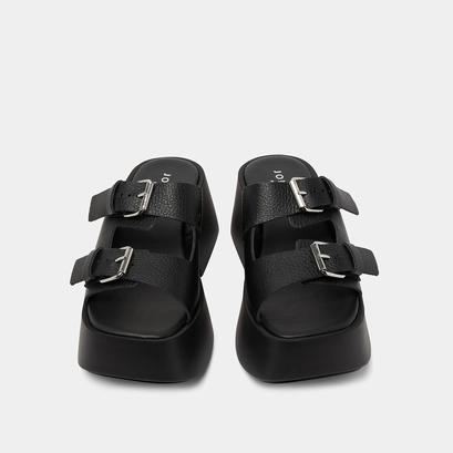Mules with thick straps, buckles and open toes in black grained leather | ENOLA