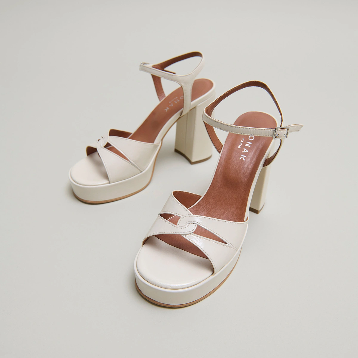Platform sandals and high heels in ecru shiny leather | JUSTINE
