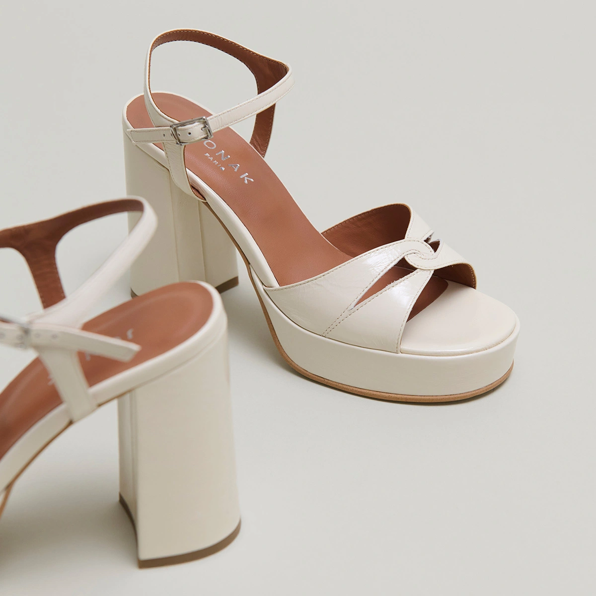 Platform sandals and high heels in ecru shiny leather | JUSTINE