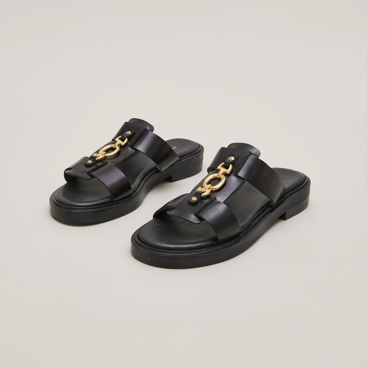 Mules with golden jaws in black leather | DOP