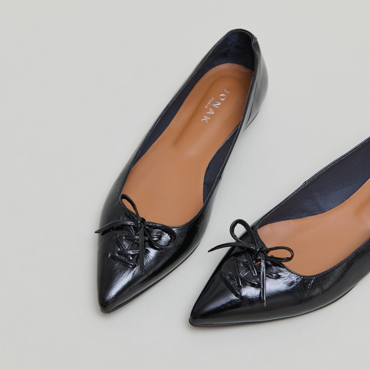 Pointed-toe lace-up ballet flats in black shiny leather | DAMY