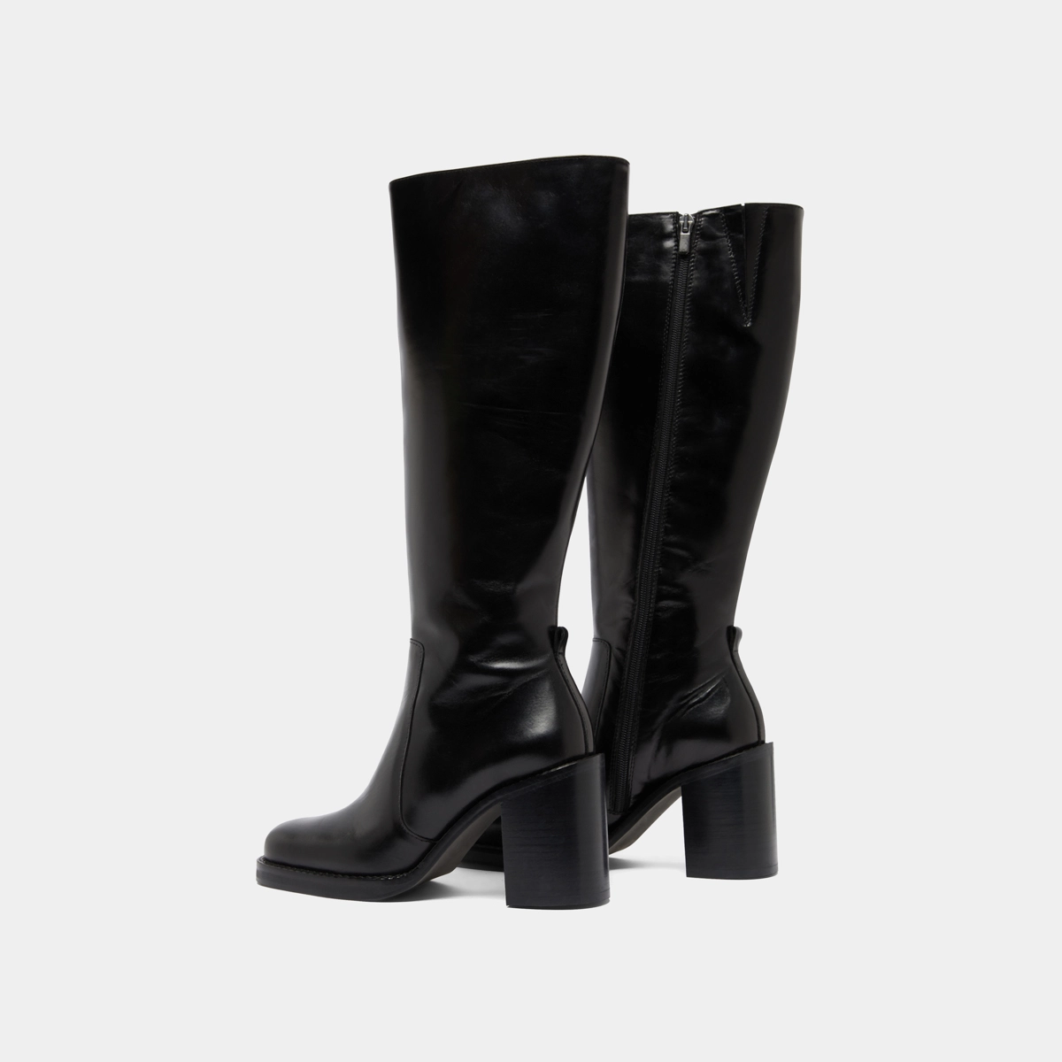 Boots with overflowing heels in black leather | BRETZEL