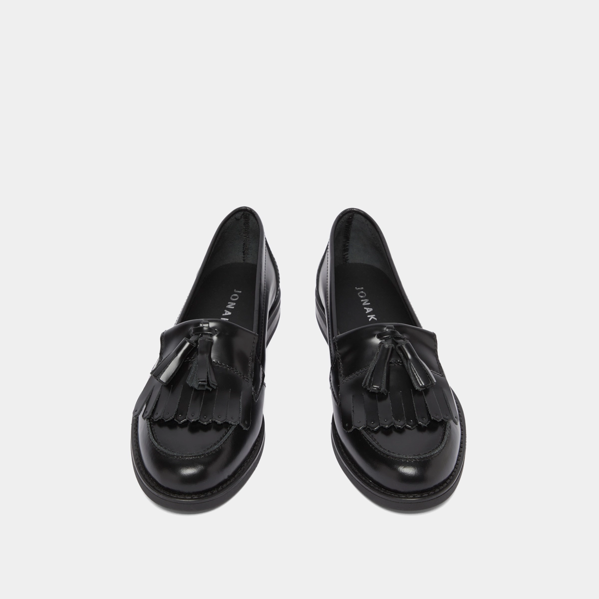 Tassel loafers in black glazed leather | NELLE