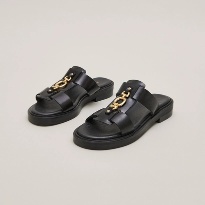 Mules with golden jaws in black leather | dop